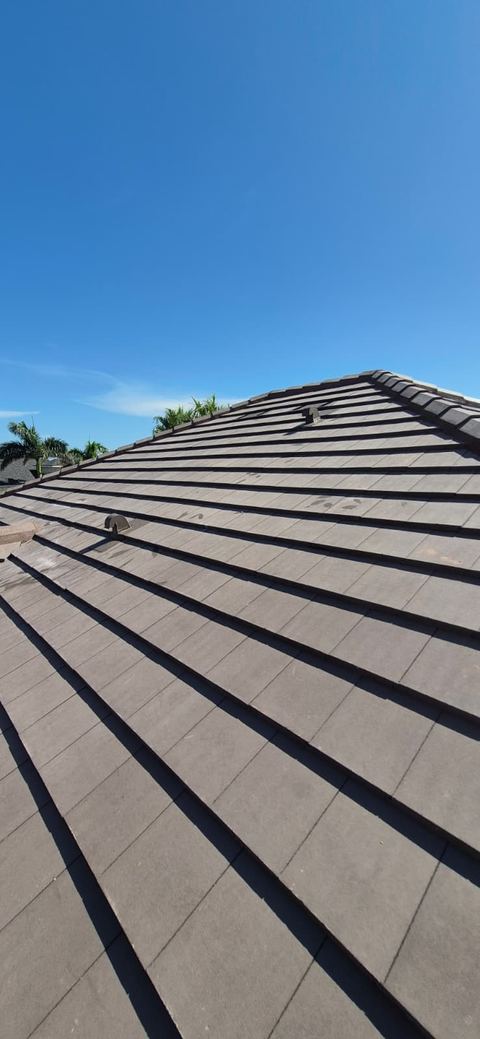 Flat concrete tile roof under a clear sky